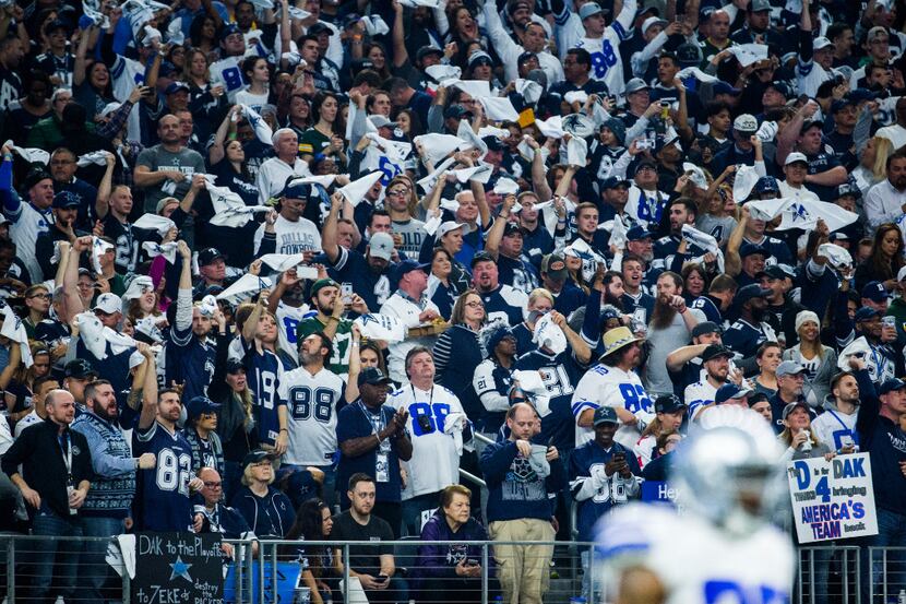 Dallas Cowboys fans cheer at the start of their divisional playoff game against the Green...