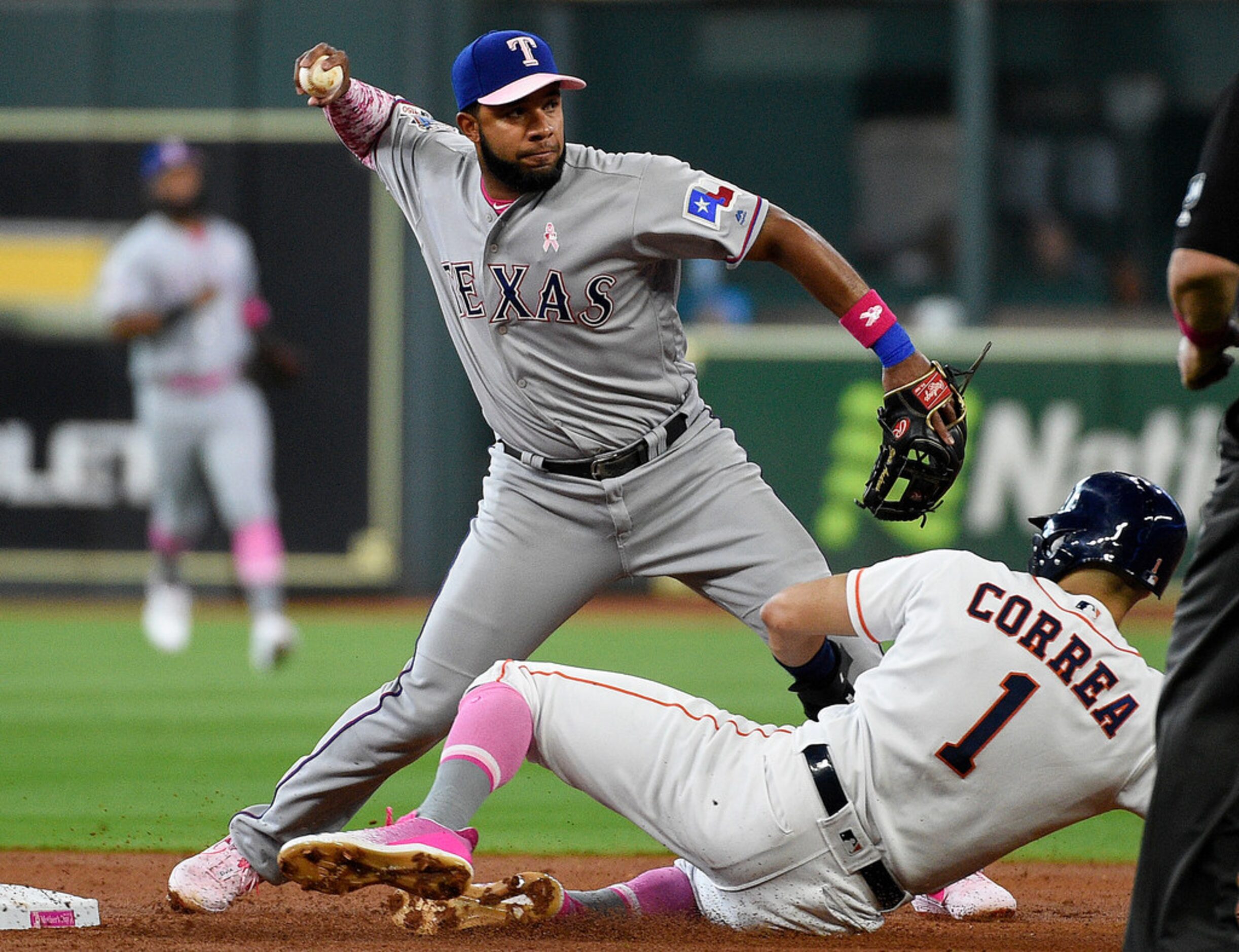 Texas Rangers shortstop Elvis Andrus, left, forces out Houston Astros' Carlos Correa, right,...