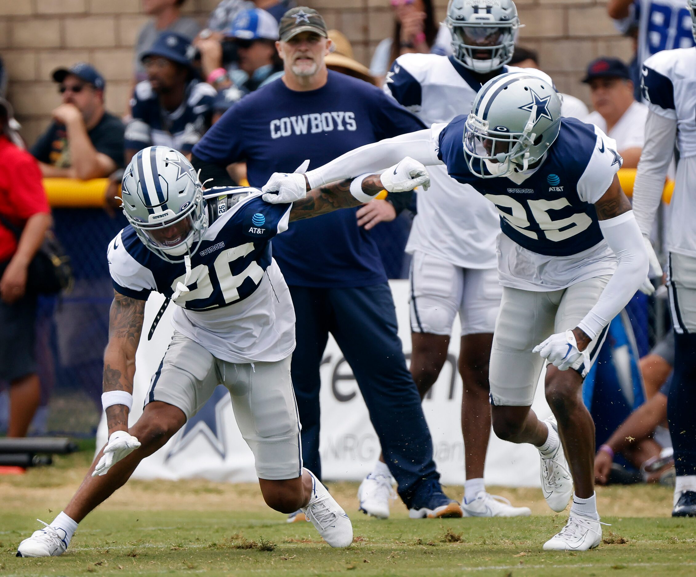 Dallas Cowboys cornerbacks Kyron Brown (26) and Nahshon Wright (25) run pass coverage drills...