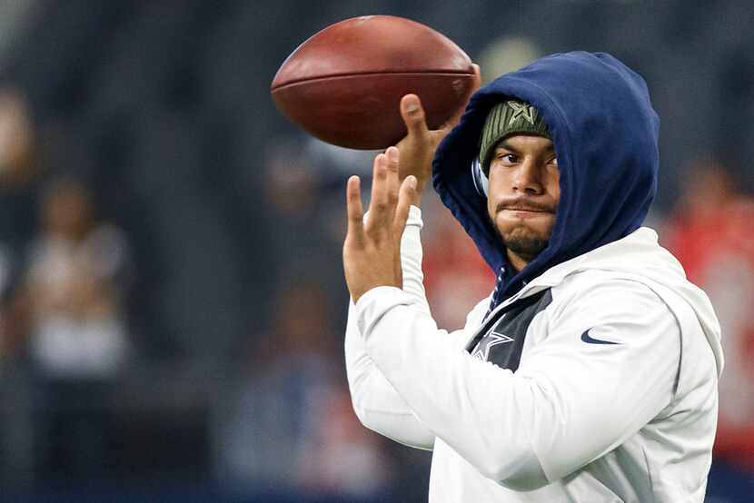 Dallas Cowboys quarterback Dak Prescott warms up before an NFL football game against the...