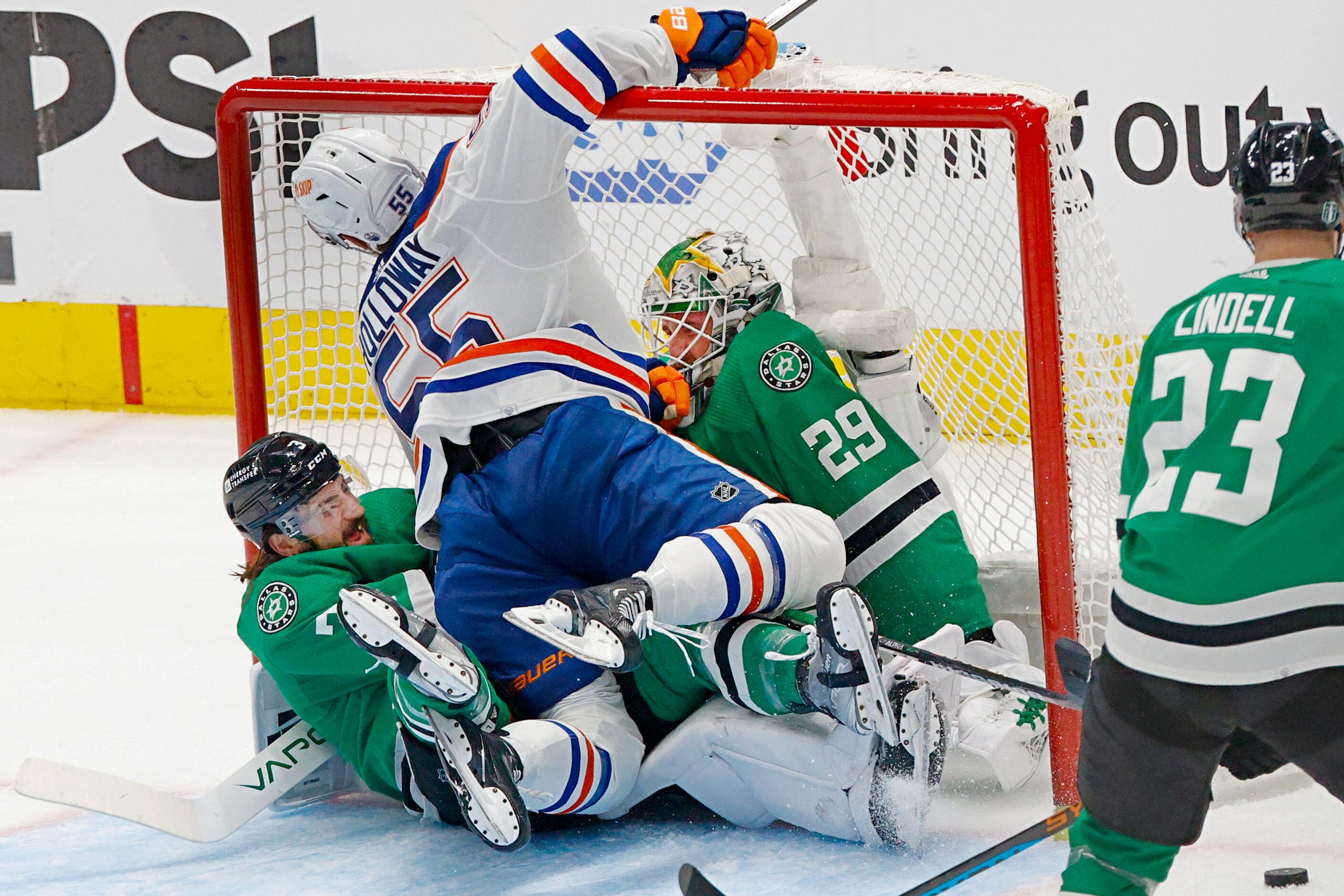 Dallas Stars defenseman Chris Tanev (3) Edmonton Oilers left wing Dylan Holloway (55) and...