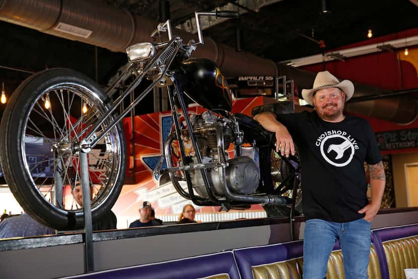 Randy Rogers poses with a motorcycle that is on the menu for $25,000 as a joke at ChopShop...