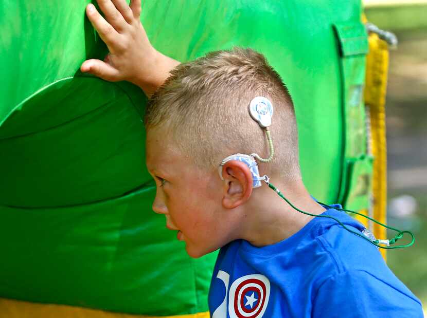 Bentley Butts, 7, of Coleman waited for his turn on the obstacle course at Cochlear Camp...