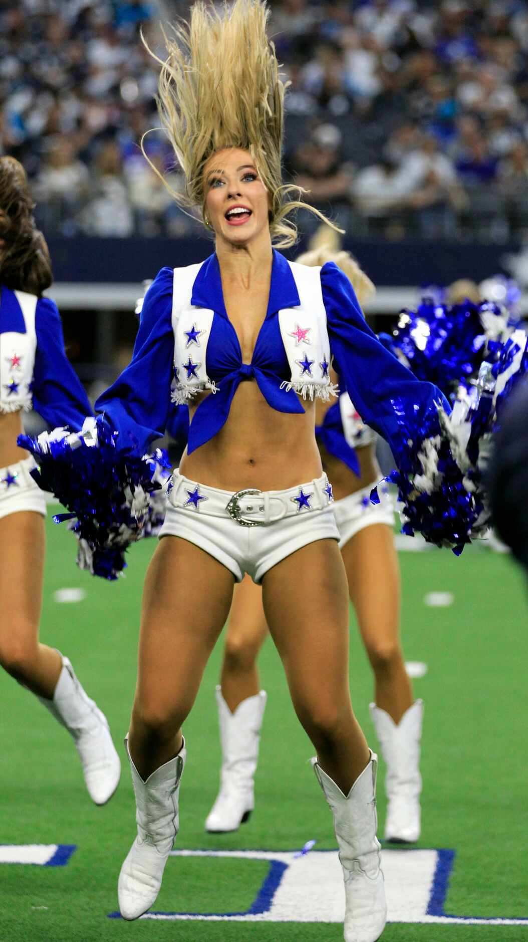 A Dallas Cowboys cheerleader has a hair-raisin experience during a break in the actionof a...