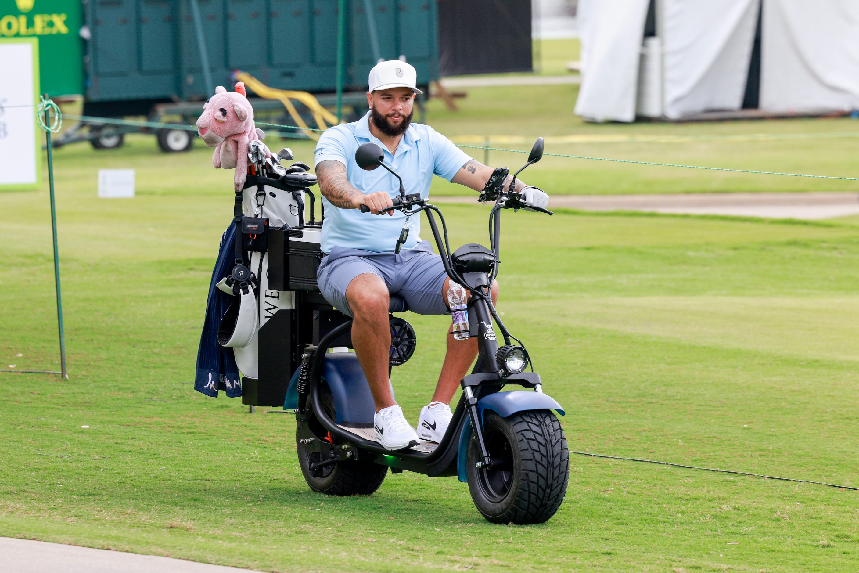 Former Dallas Mavericks player Deron Williams rides an electric scooter after teeing off at...