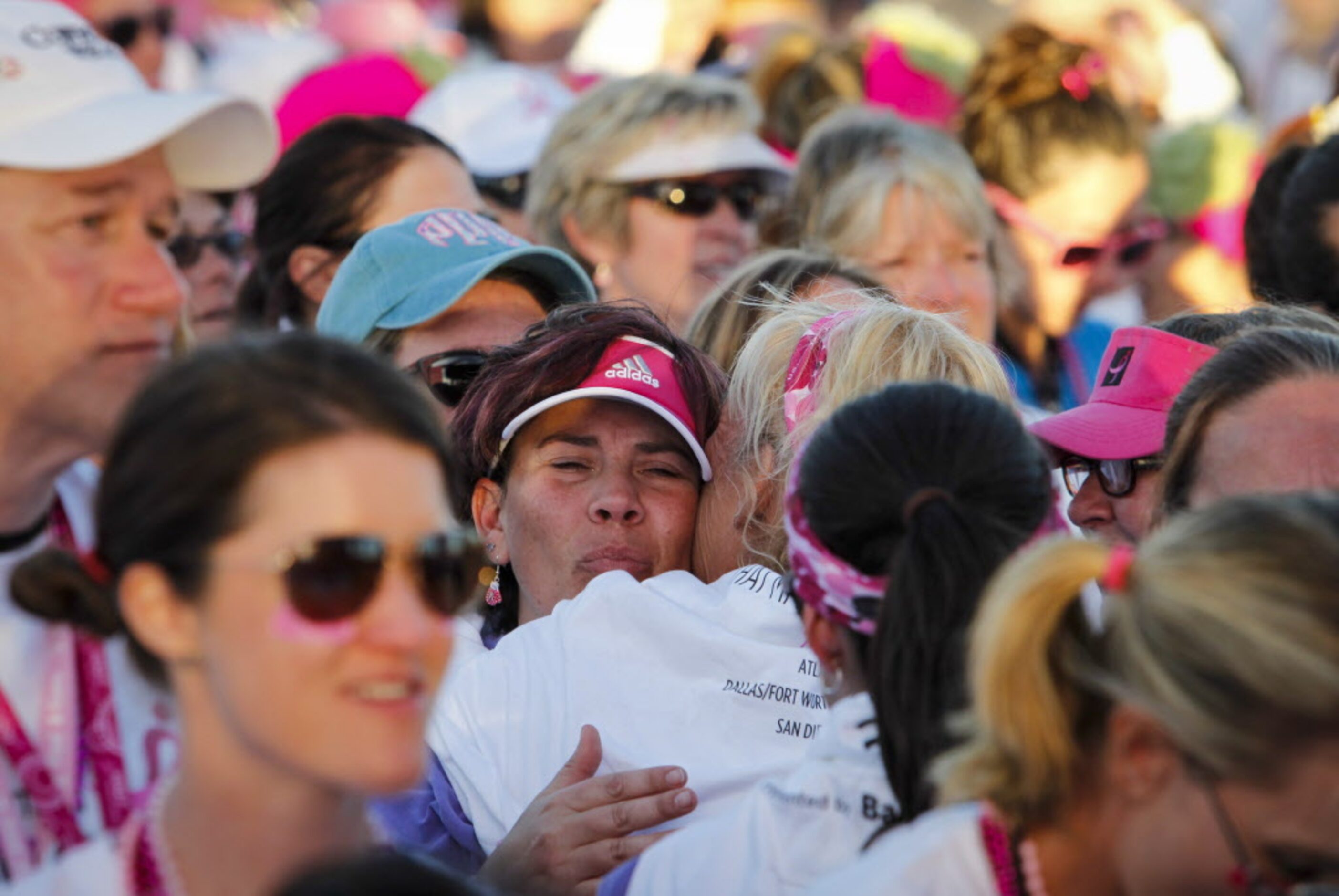 Walkers embrace during the closing ceremony of the 2014 Susan G. Komen Dallas/Fort Worth...