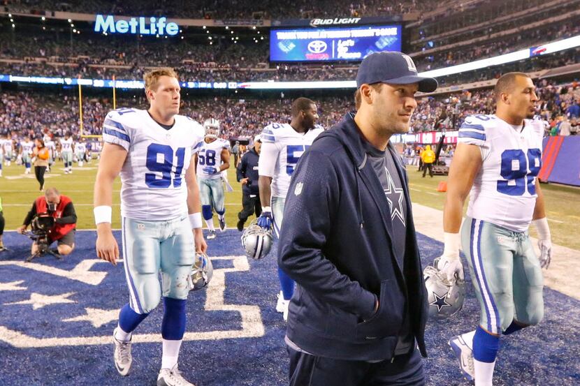 Injured Dallas Cowboys quarterback Tony Romo (9) walks off the field after the Cowboys'...