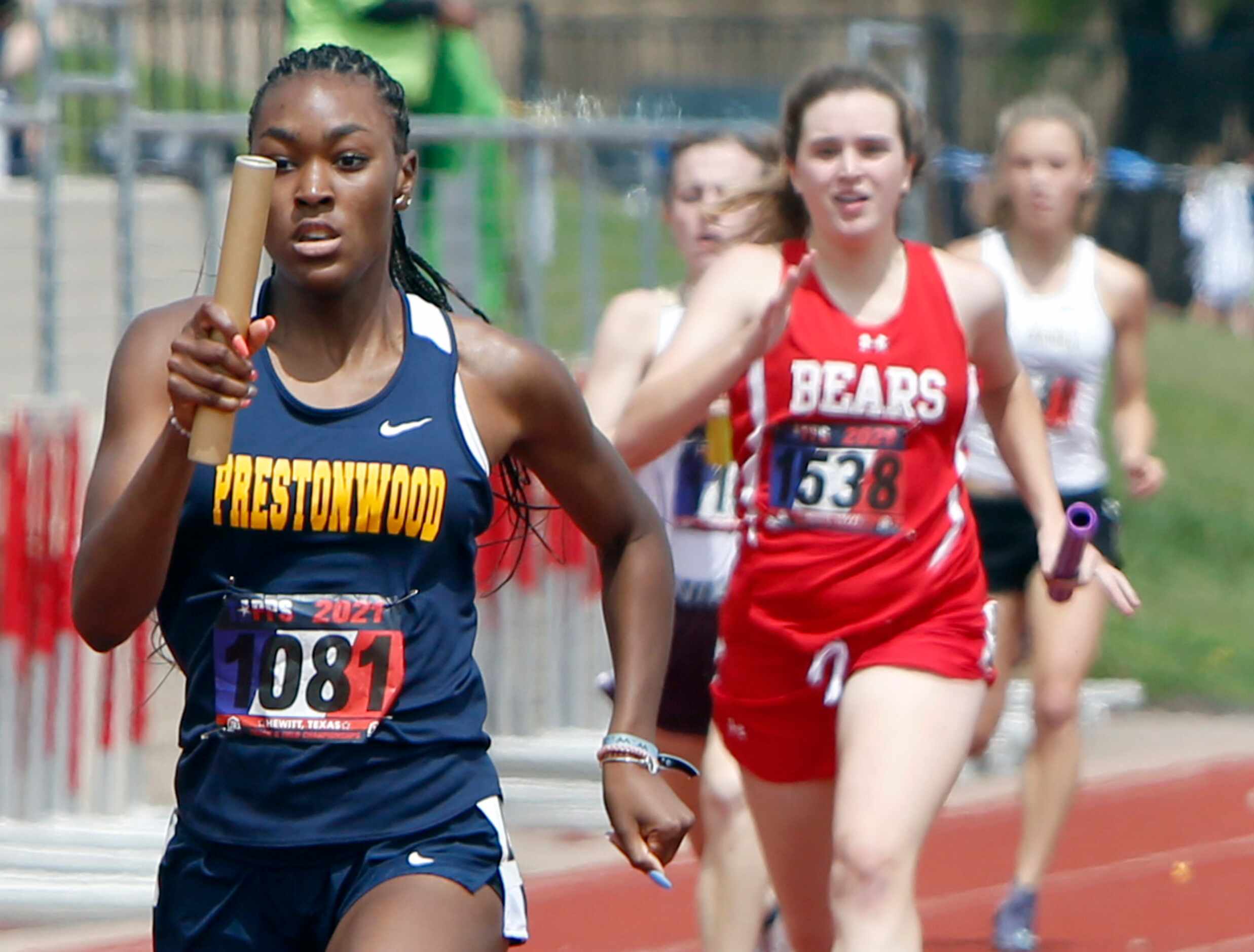Prestonwood sprinter Nadia Thomas carries the baton for a first place finish as the anchor...