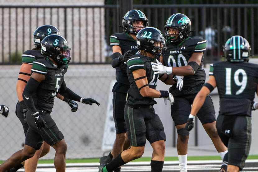Prosper’s Kaiden Booker (22) celebrates with teammates after he blocked a Rockwall punt in...