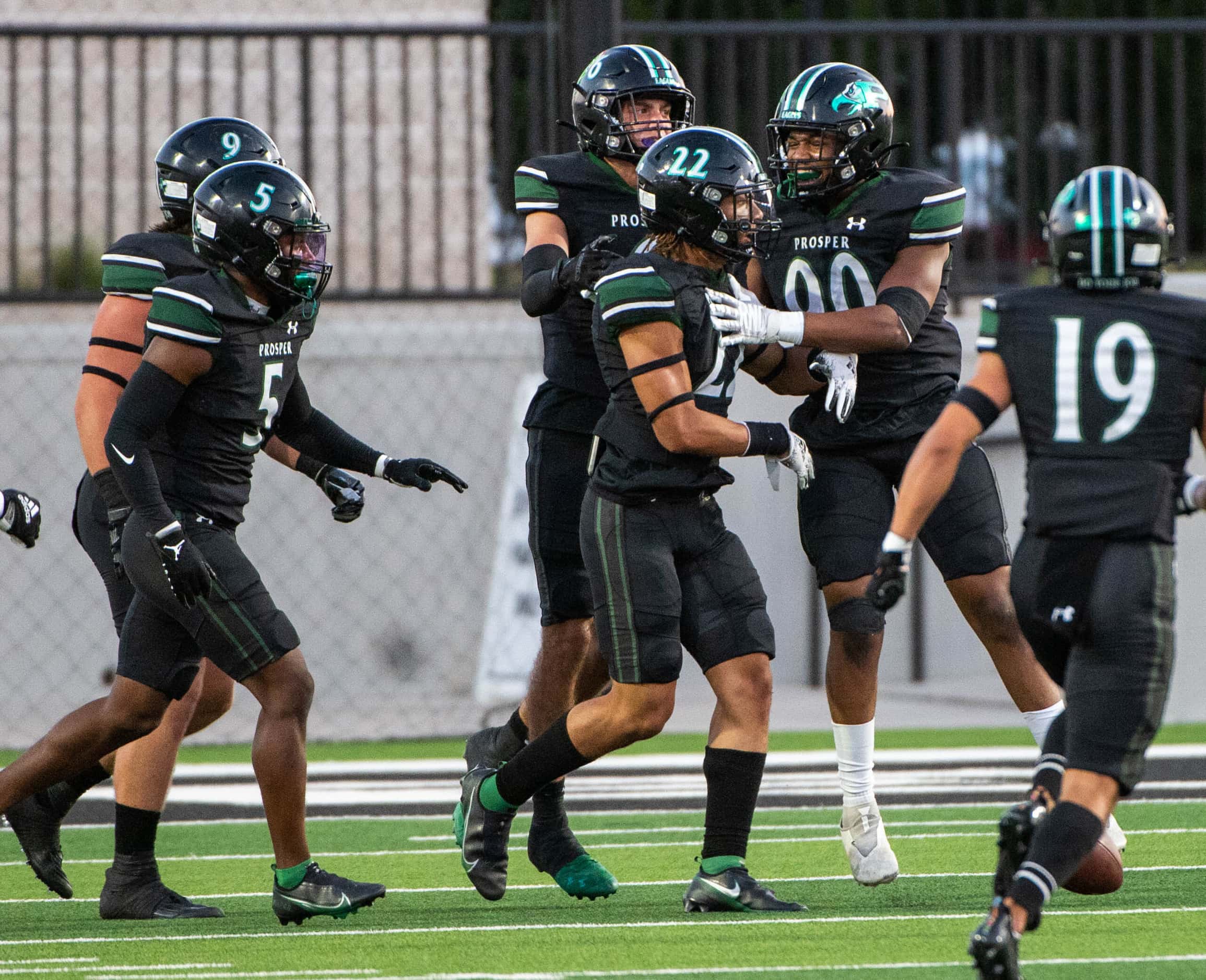Prosper’s Kaiden Booker (22) celebrates with teammates after he blocked a Rockwall punt in...