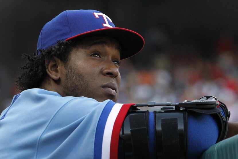 Injured Texas pitcher Neftali Feliz is pictured in the dugout during the Detroit Tigers vs....