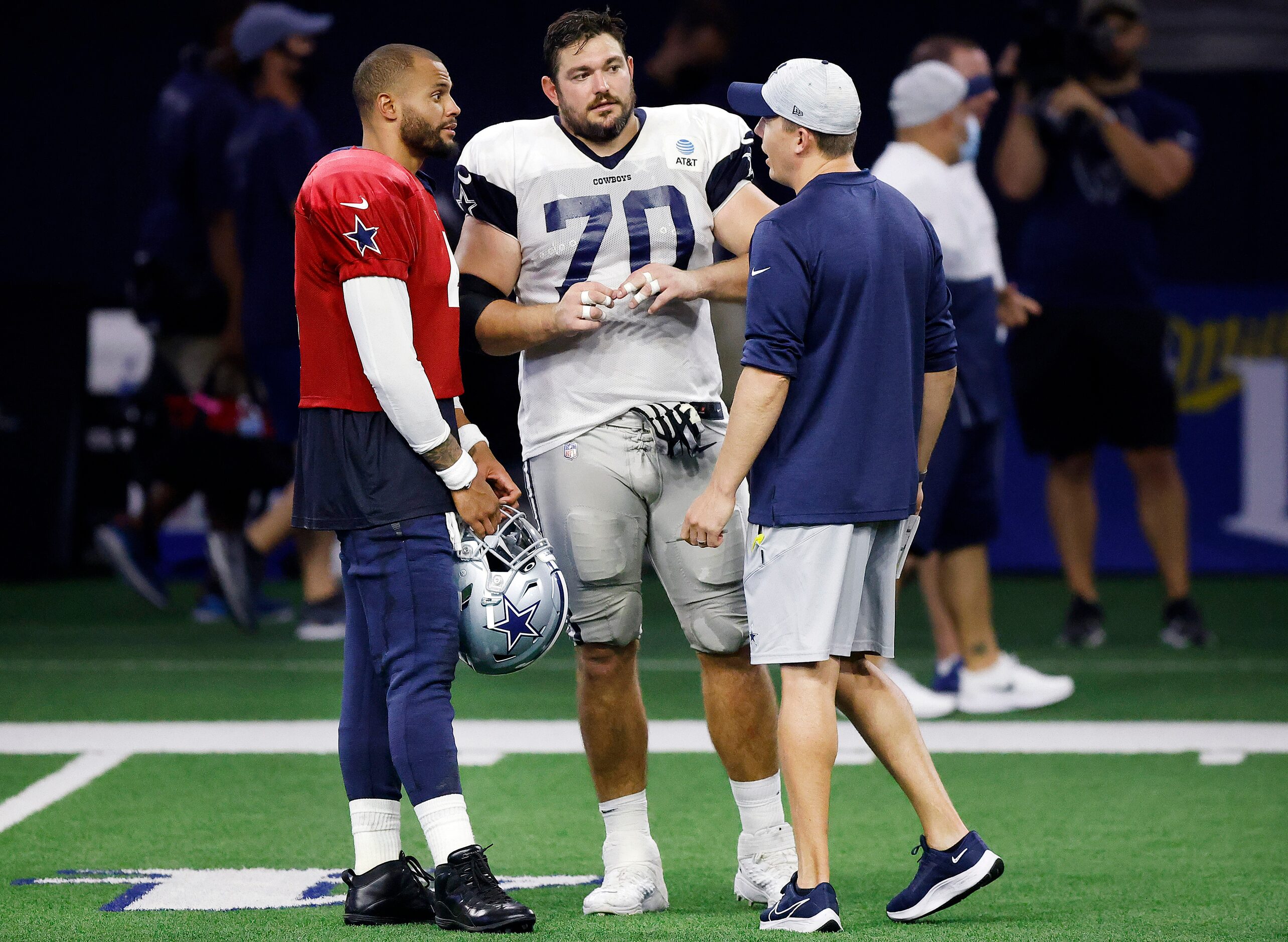 Dallas Cowboys guard Zack Martin (70) and quarterback Dak Prescott (4) visit with offensive...