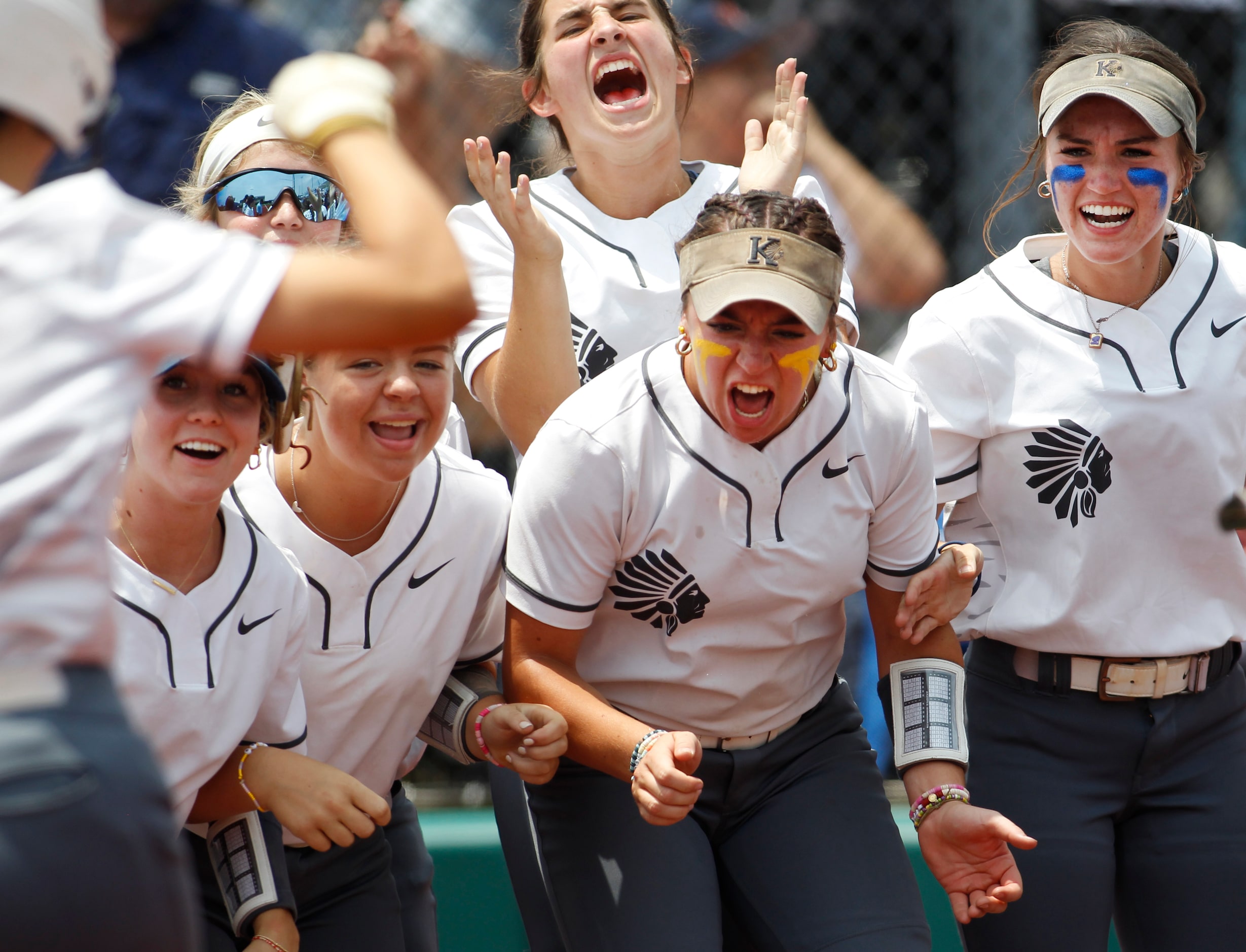 Keller players form a welcoming committee for teammate Kaiya Fabela (14) at home plate after...