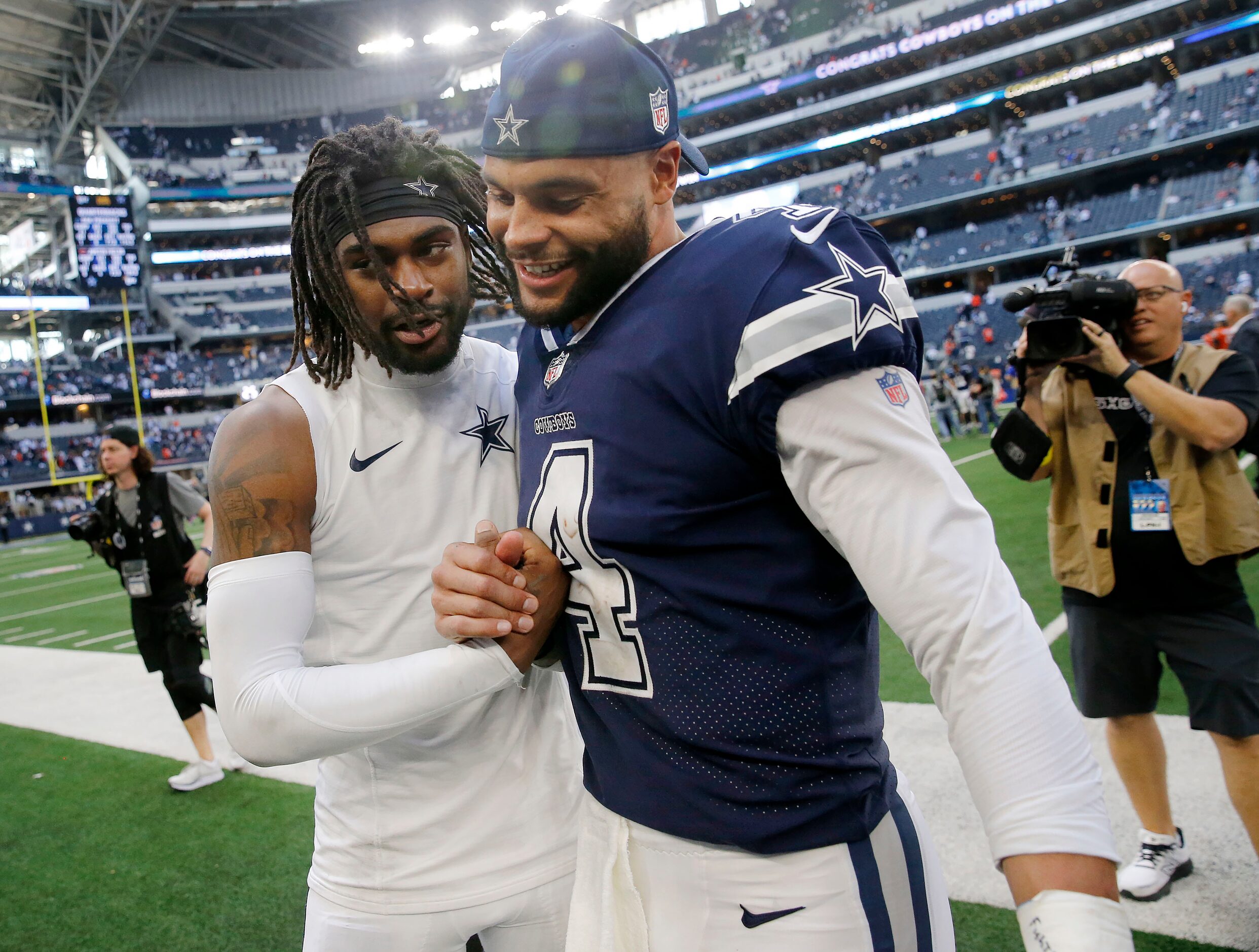 Dallas Cowboys quarterback Dak Prescott (right) and cornerback Trevon Diggs (7) congratulate...