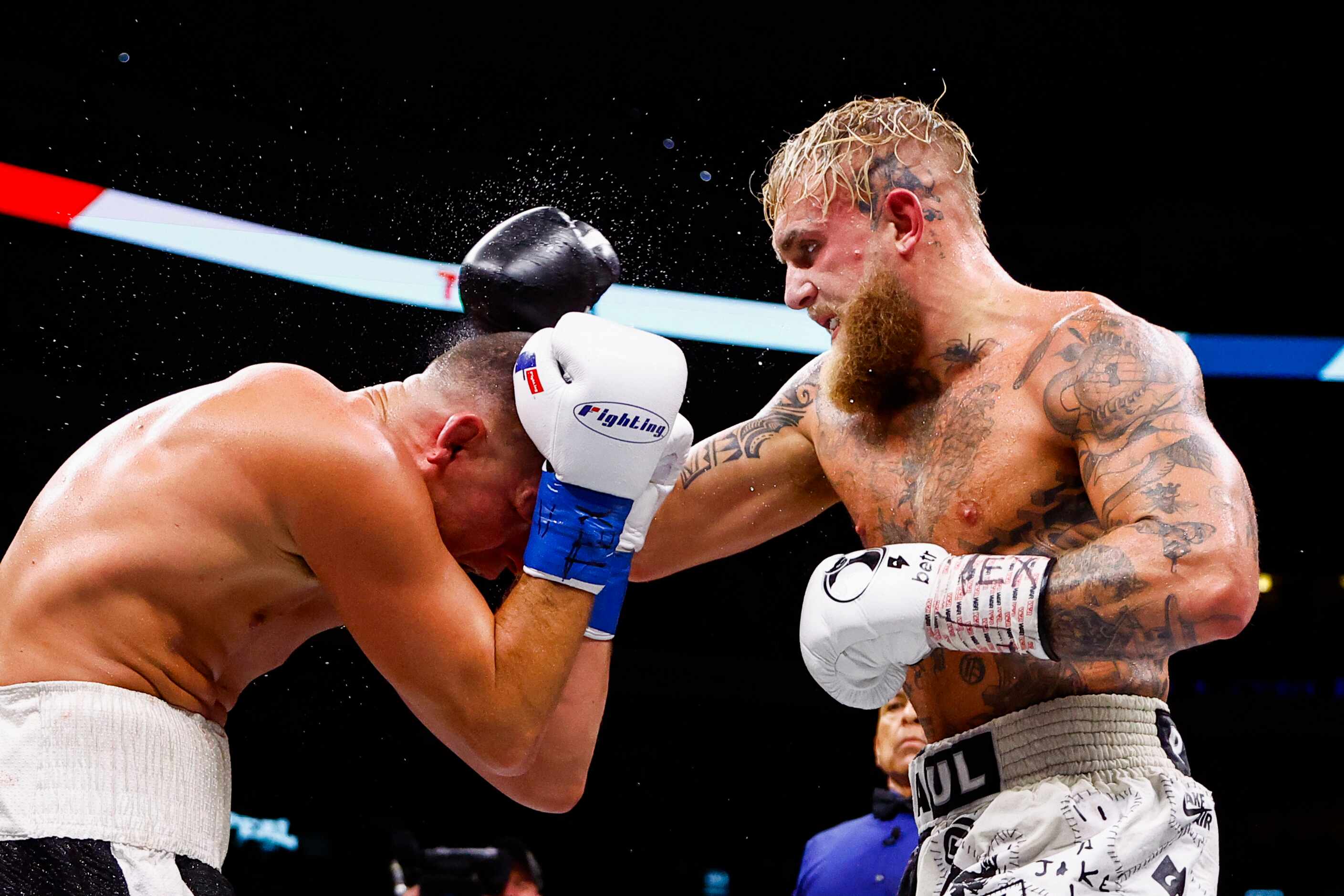 Jake Paul, right, lands a punch on Nate Diaz during a boxing match in Dallas, Saturday,...