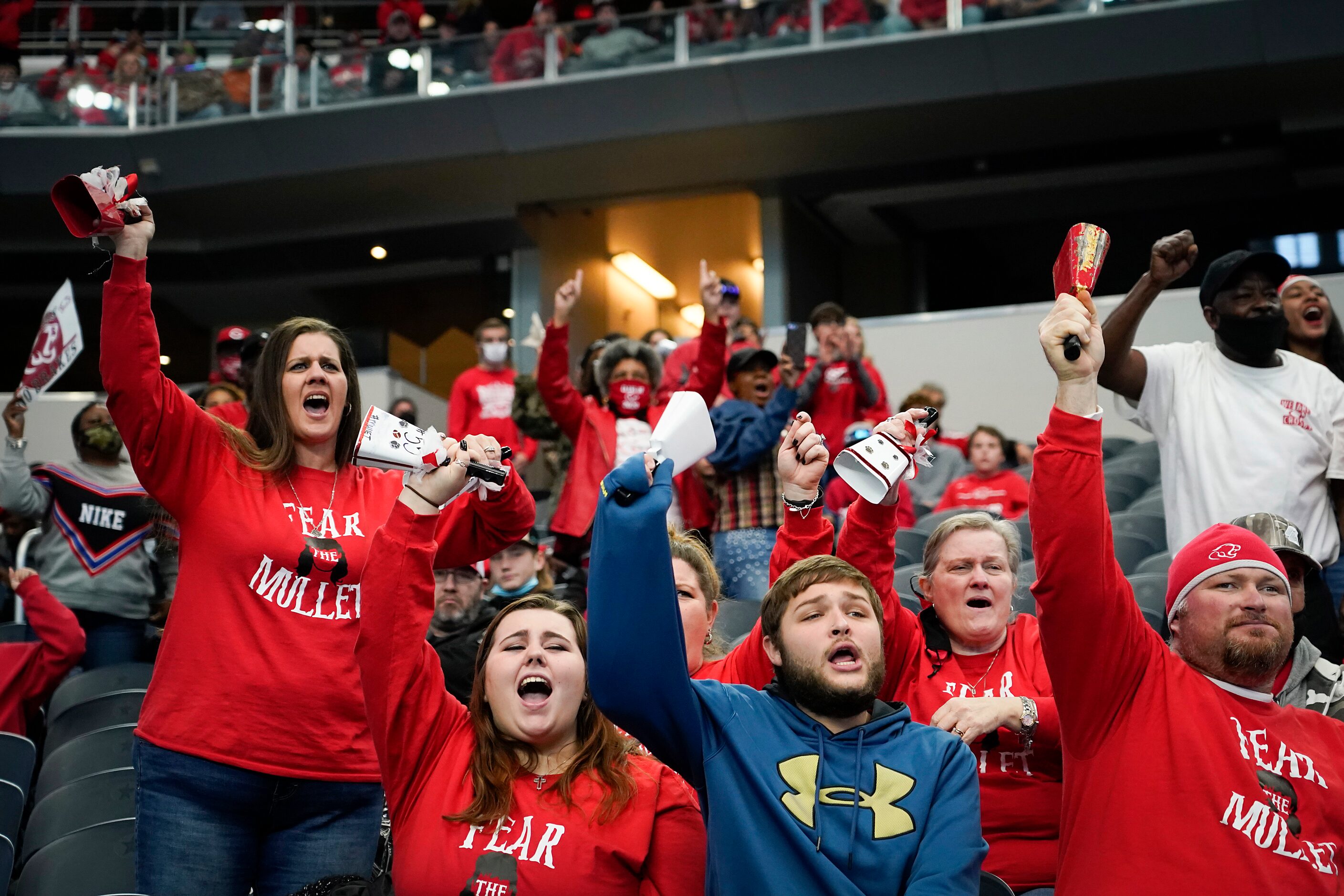 Crosby fans cheer their team during the first half of the Class 5A Division II state...