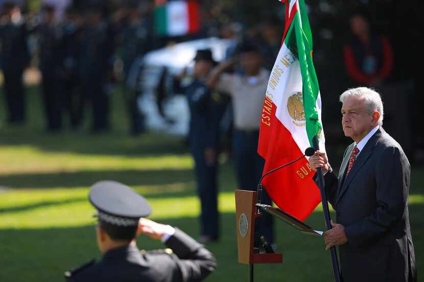 President of Mexico Andres Manuel Lopez Obrador holds the Mexican flag during the ceremony...