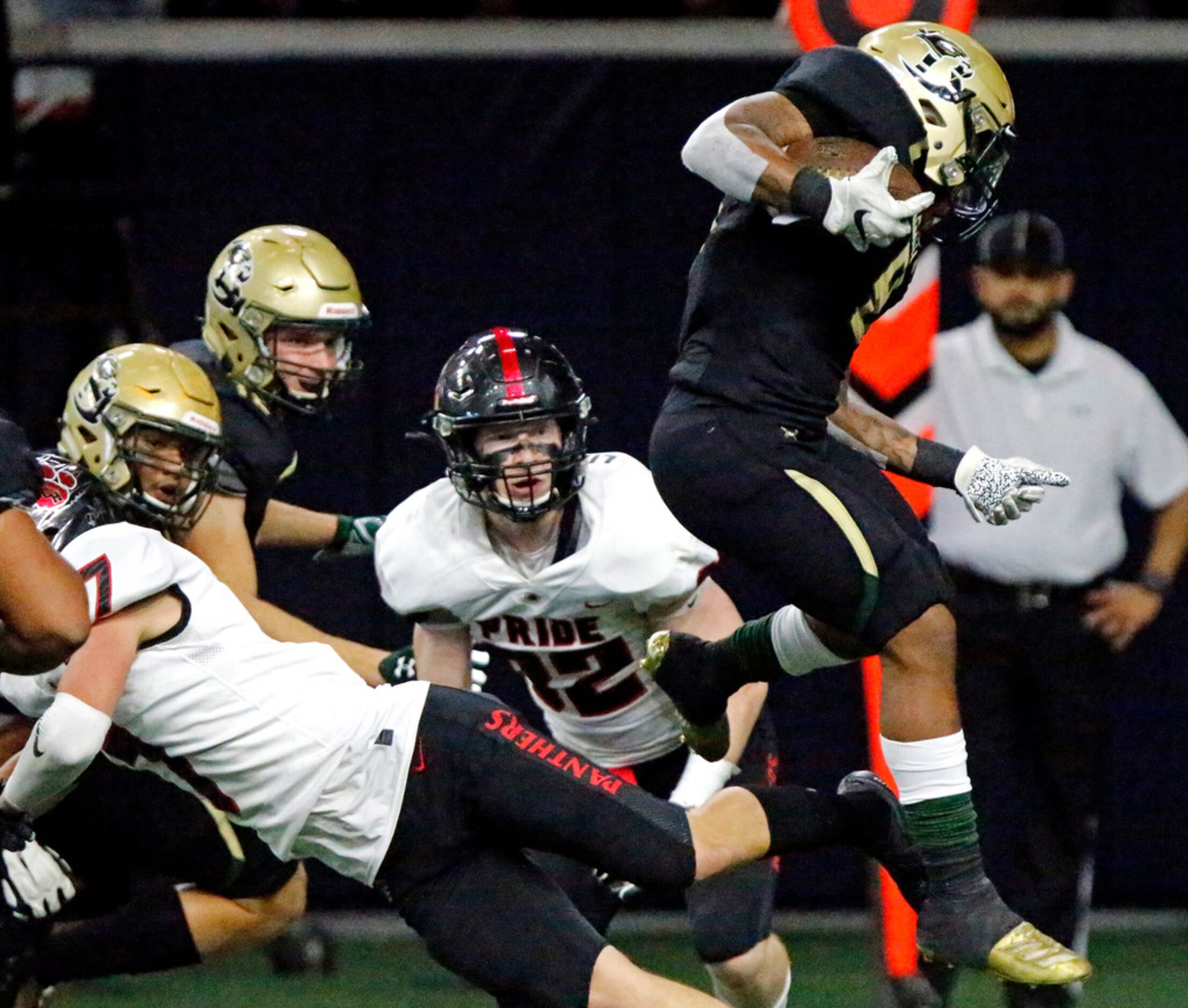 Birdville High School wide receiver Cade Shaffer (6) hurdles Colleyville Heritage High...