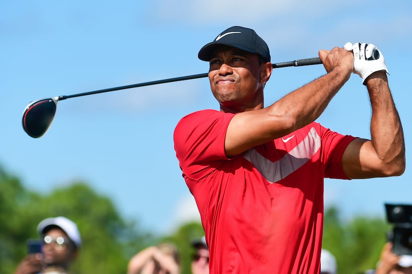 Tiger Woods follows his ball at the fourth tee during the last round of the Hero World...