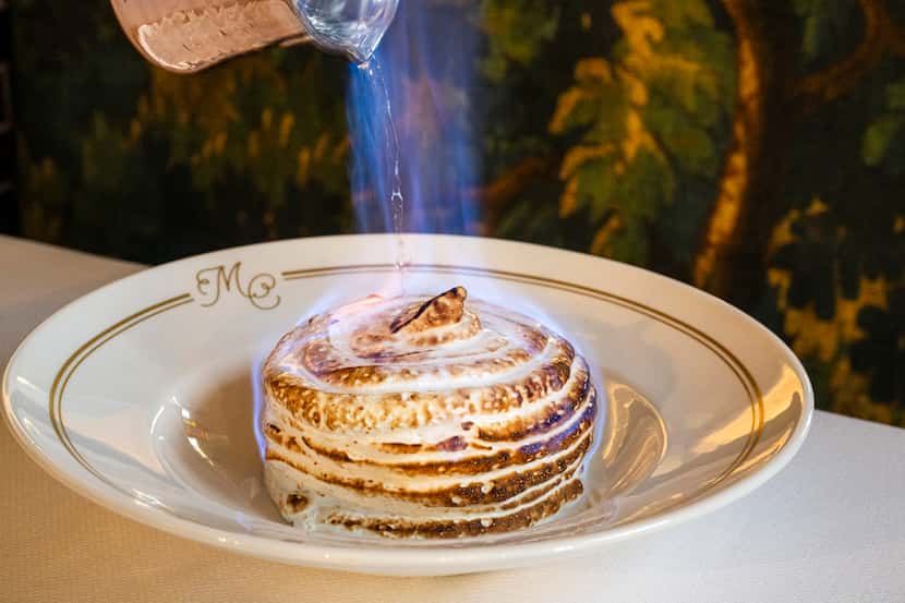 Mister Charles' play on a Baked Alaska dessert is doused with Licor 43, lit on fire. The...