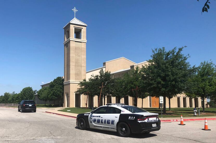 A police car was parked outside St. Cecilia Catholic Church on Wednesday.