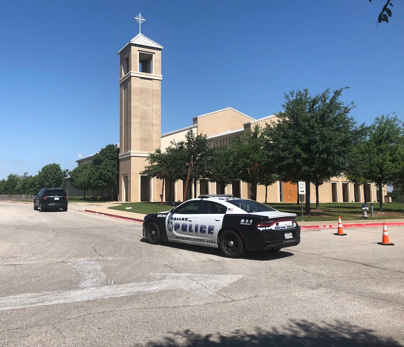 A police car was parked outside St. Cecilia Catholic Church on Wednesday.