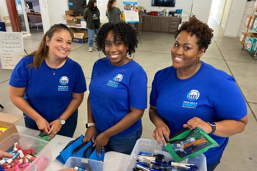 Origin Bank workers assemble bags of supplies for kids before the school year starts.