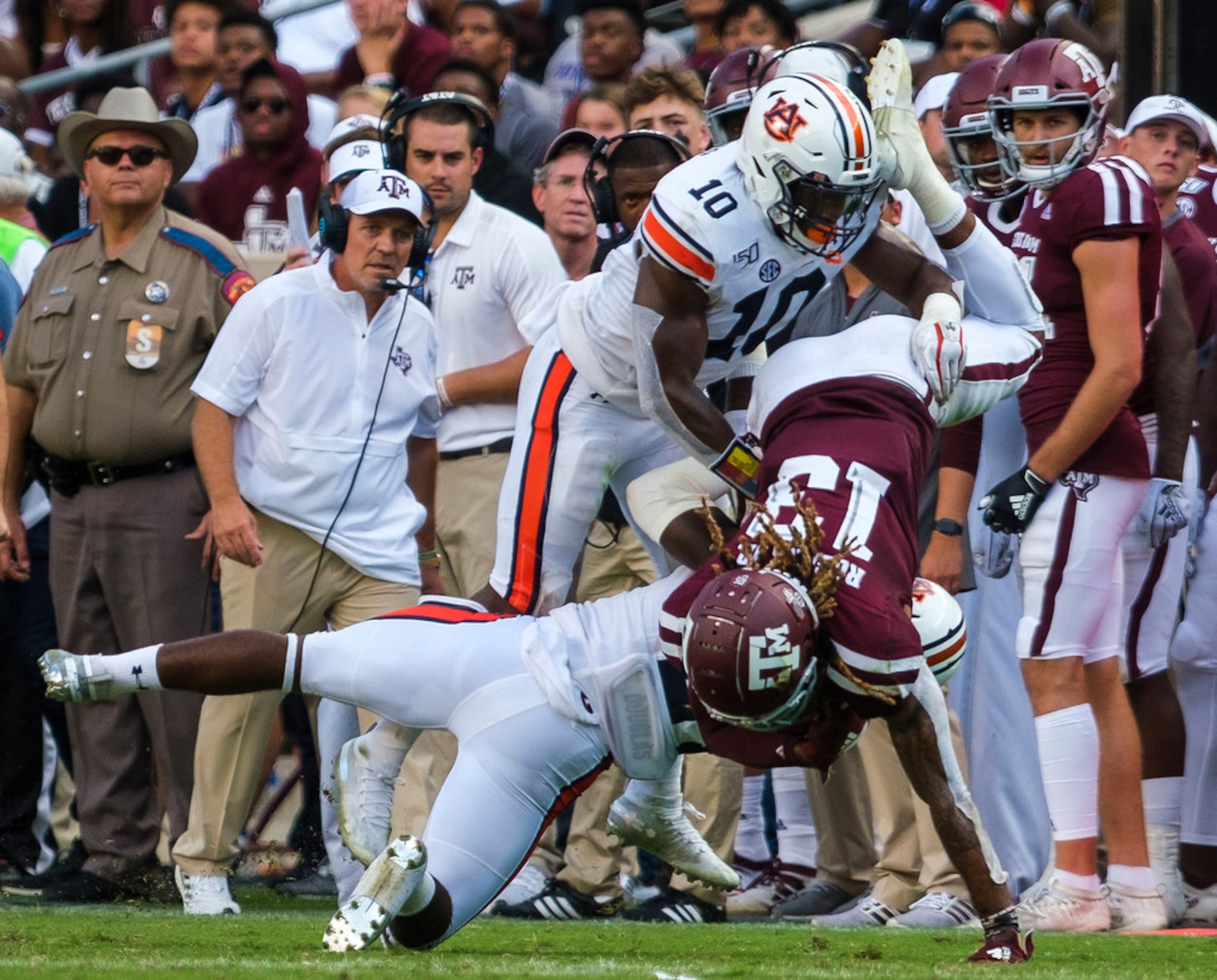 Texas A&M wide receiver Kendrick Rogers (13) is upended by Auburn defensive back Daniel...