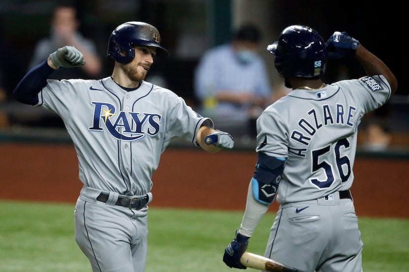 Tampa Bay Rays Brandon Lowe (8) is congratulated on his solo home run by teammate Randy...