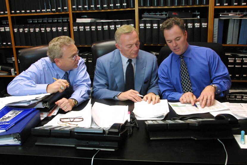 Dallas Cowboys owner Jerry Jones, center, confers with son Stephen Jones, right, and coach...