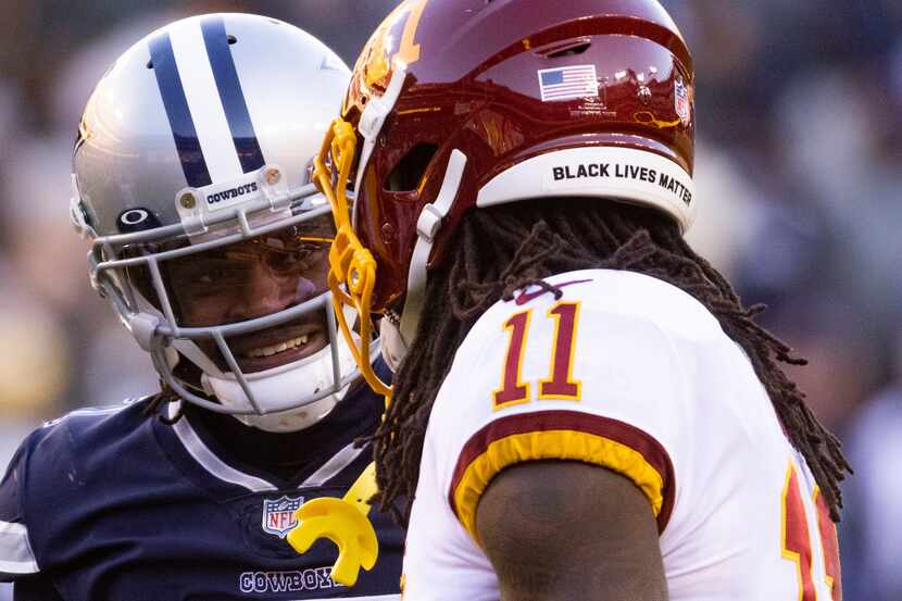 Washington Football Team wide receiver Cam Sims (11) chats with Dallas Cowboys cornerback...