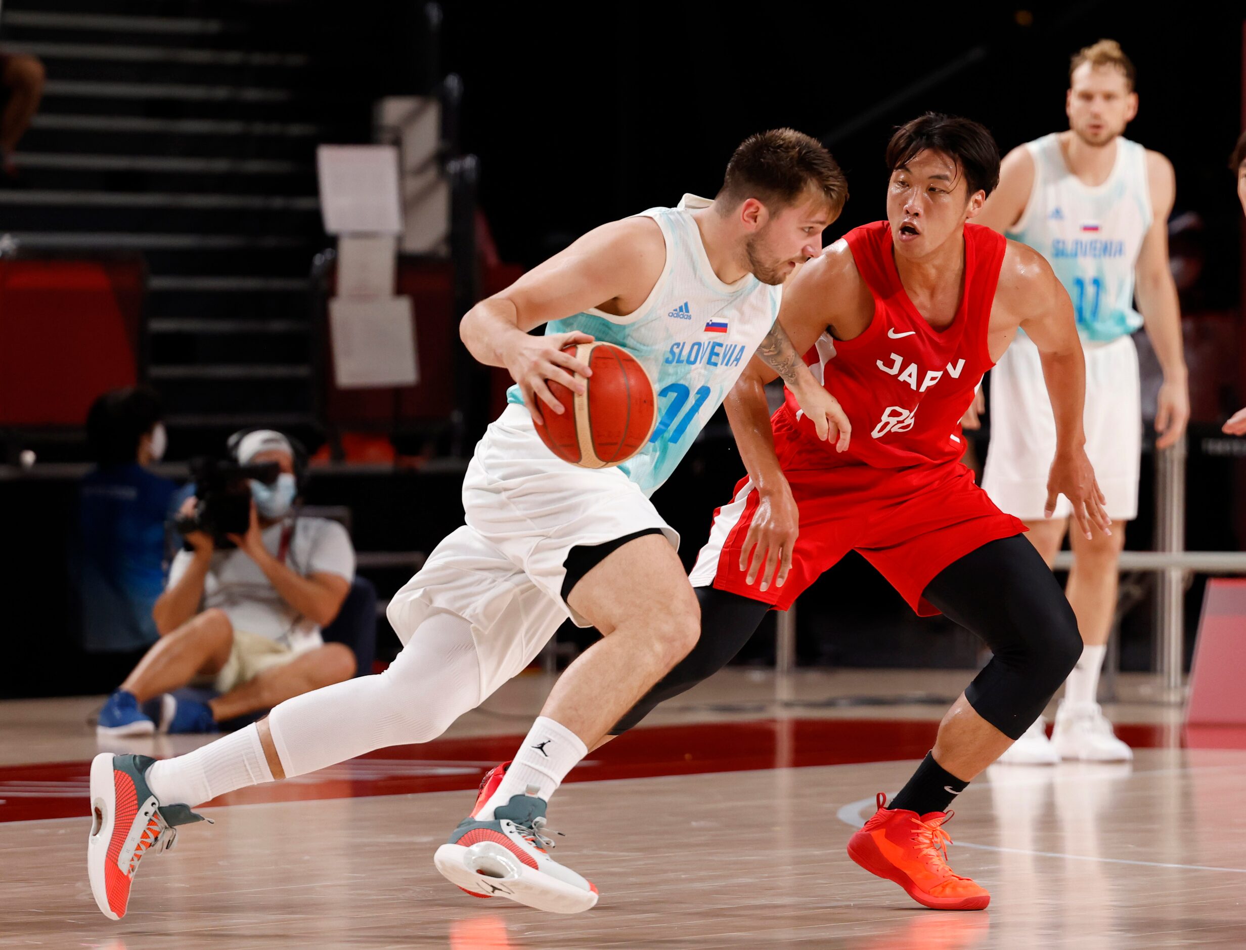 Slovenia’s Luka Doncic (77) drives on Japan’s Tenketsu Harimoto (88) in a basketball game...