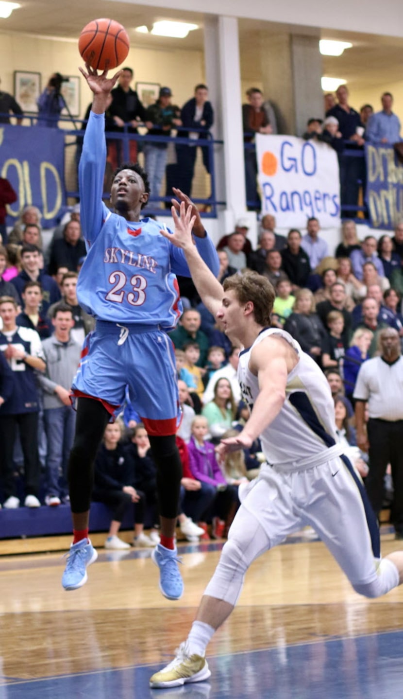 Dallas Skyline guard Marcus Garrett (23) gets off a jump shot over the defense of Jesuit...