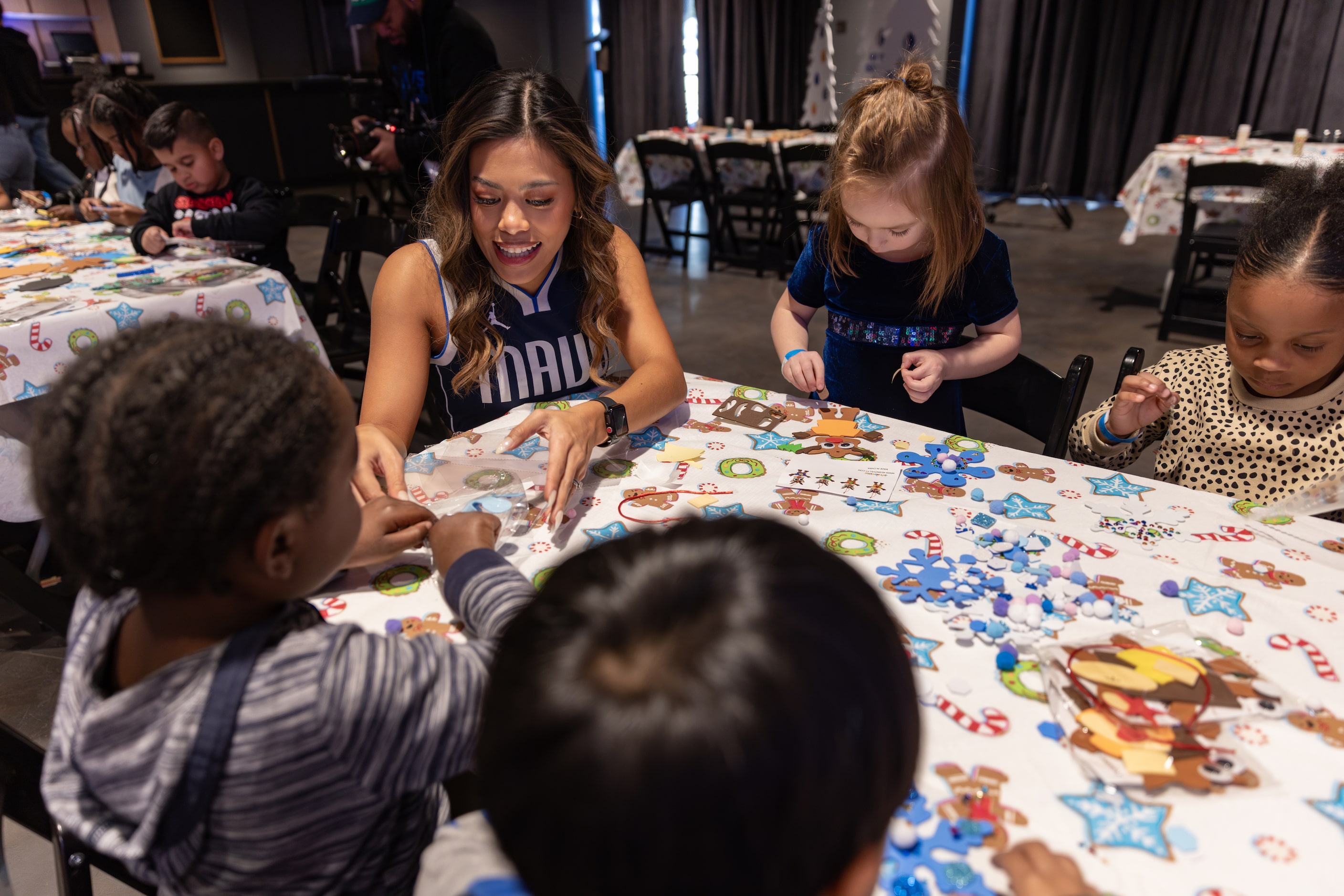 D-Town Crew member Amber Sathorn helps kids with crafts during the Cookies With Santa event...