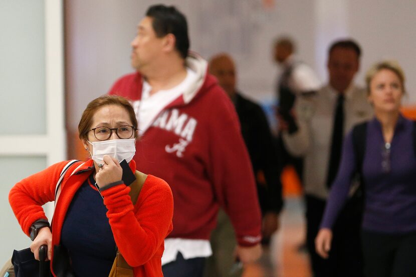 Vinnie McKinzie of Plano arrived Tuesday at DFW International Airport after a flight home...