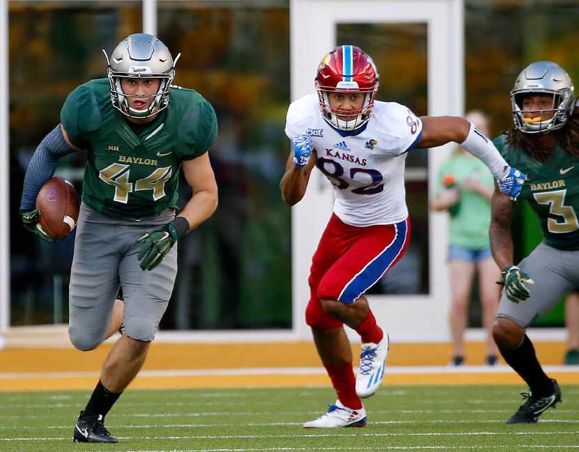 FILE - Baylor linebacker Clay Johnston (44) returns an interception past Kansas wide...