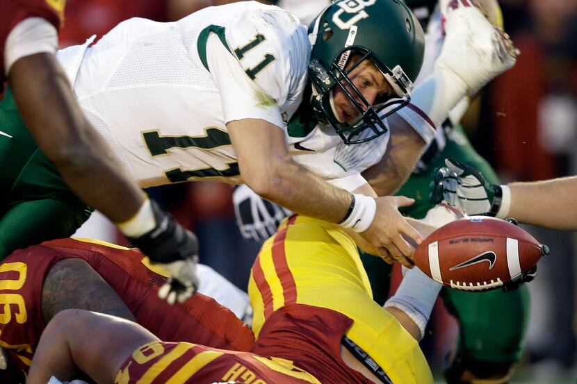 Baylor quarterback Nick Florence (11) fumbles the ball into the end zone over Iowa State...