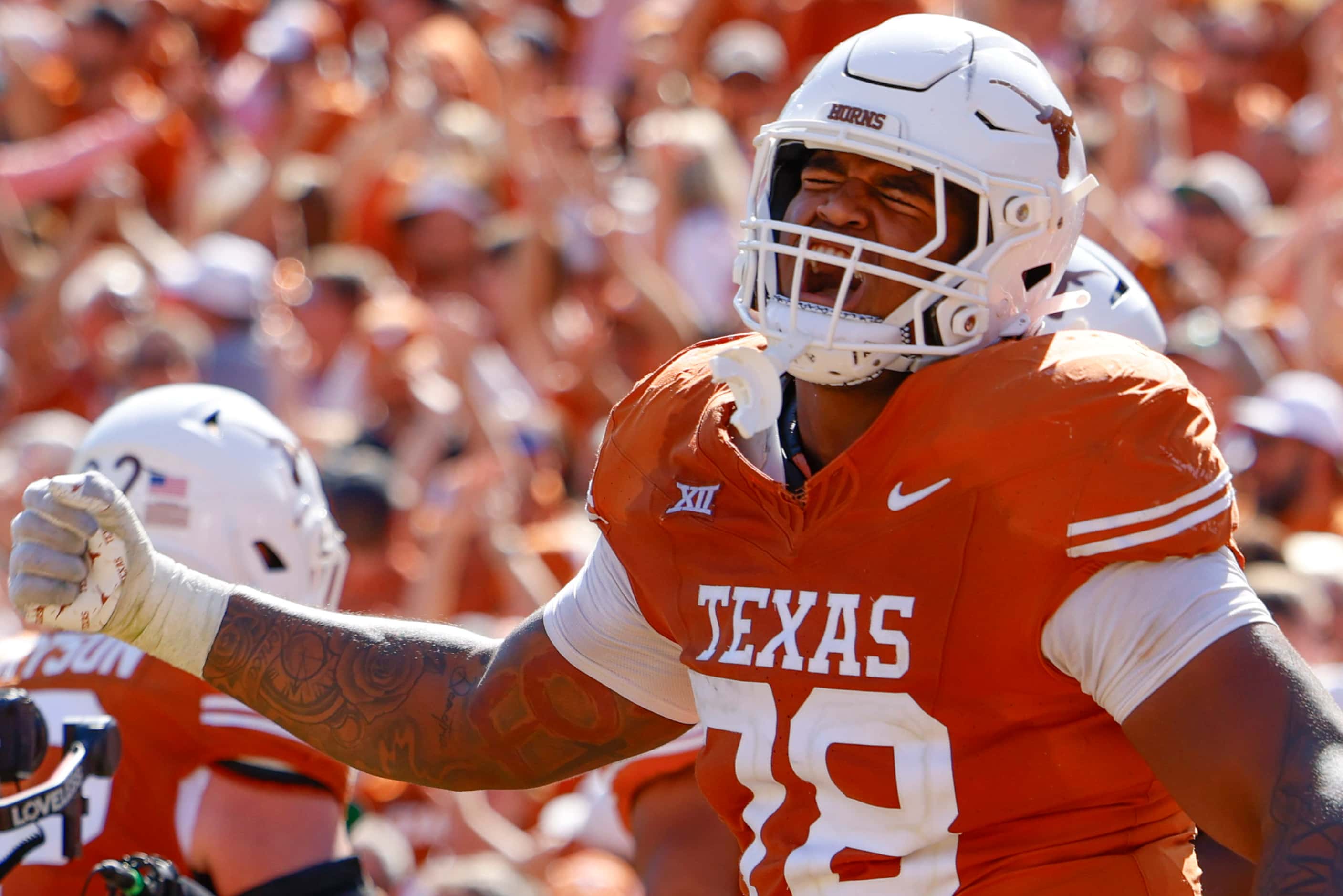 Texas offensive lineman Kelvin Banks Jr. cheers after a touchdown during the second half of...