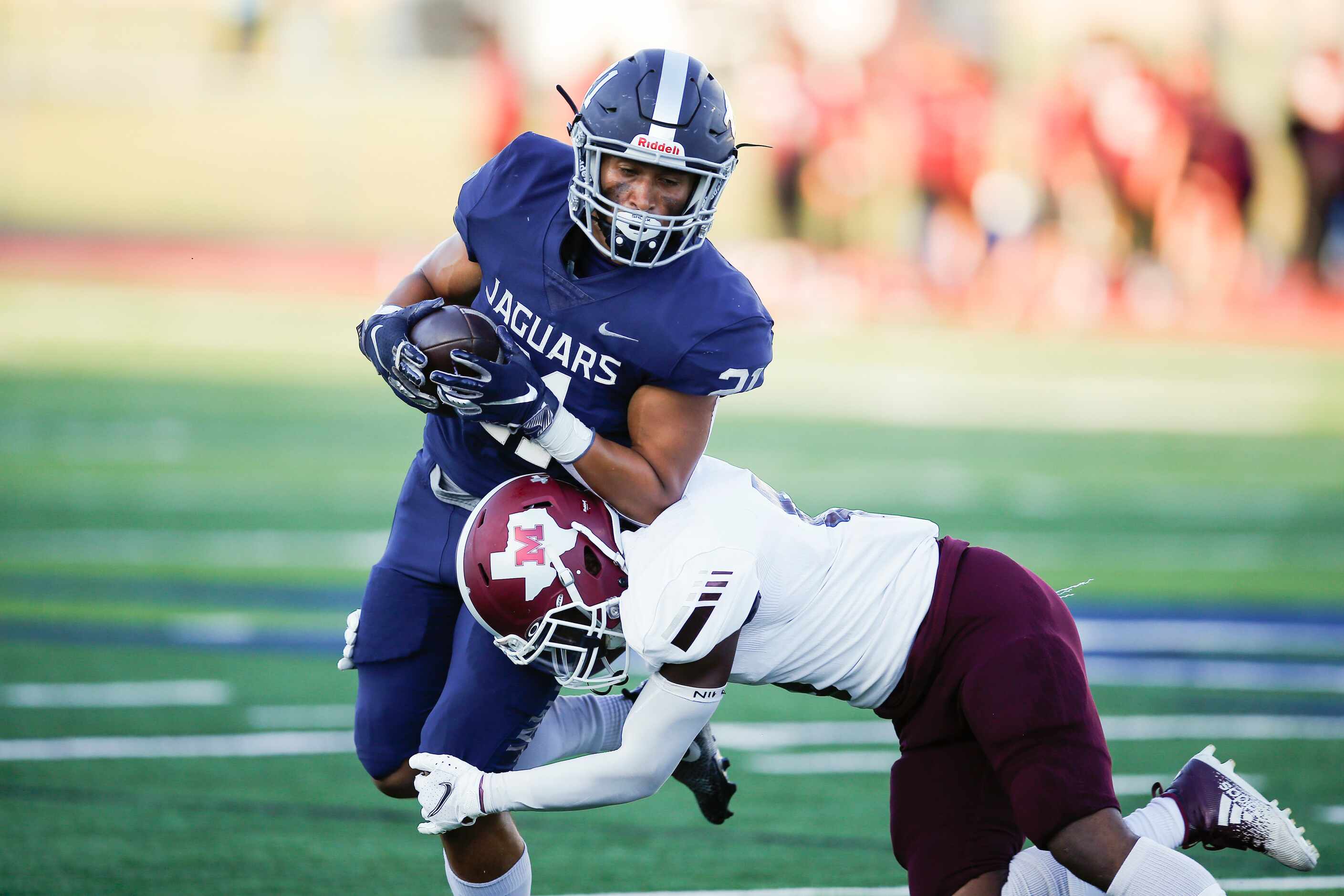 Flower Mound senior running back Max Ritchie (21) carries the ball as Mesquite senior...