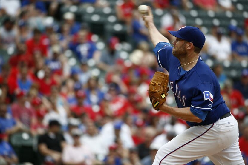 Texas Rangers starting pitcher Colby Lewis (48) pitches against Los Angeles Angels at Globe...