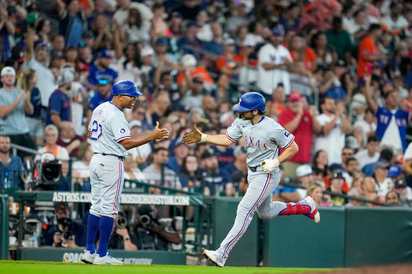 Texas Rangers' Josh Smith, right, celebrates his two-run home run against the Houston Astros...