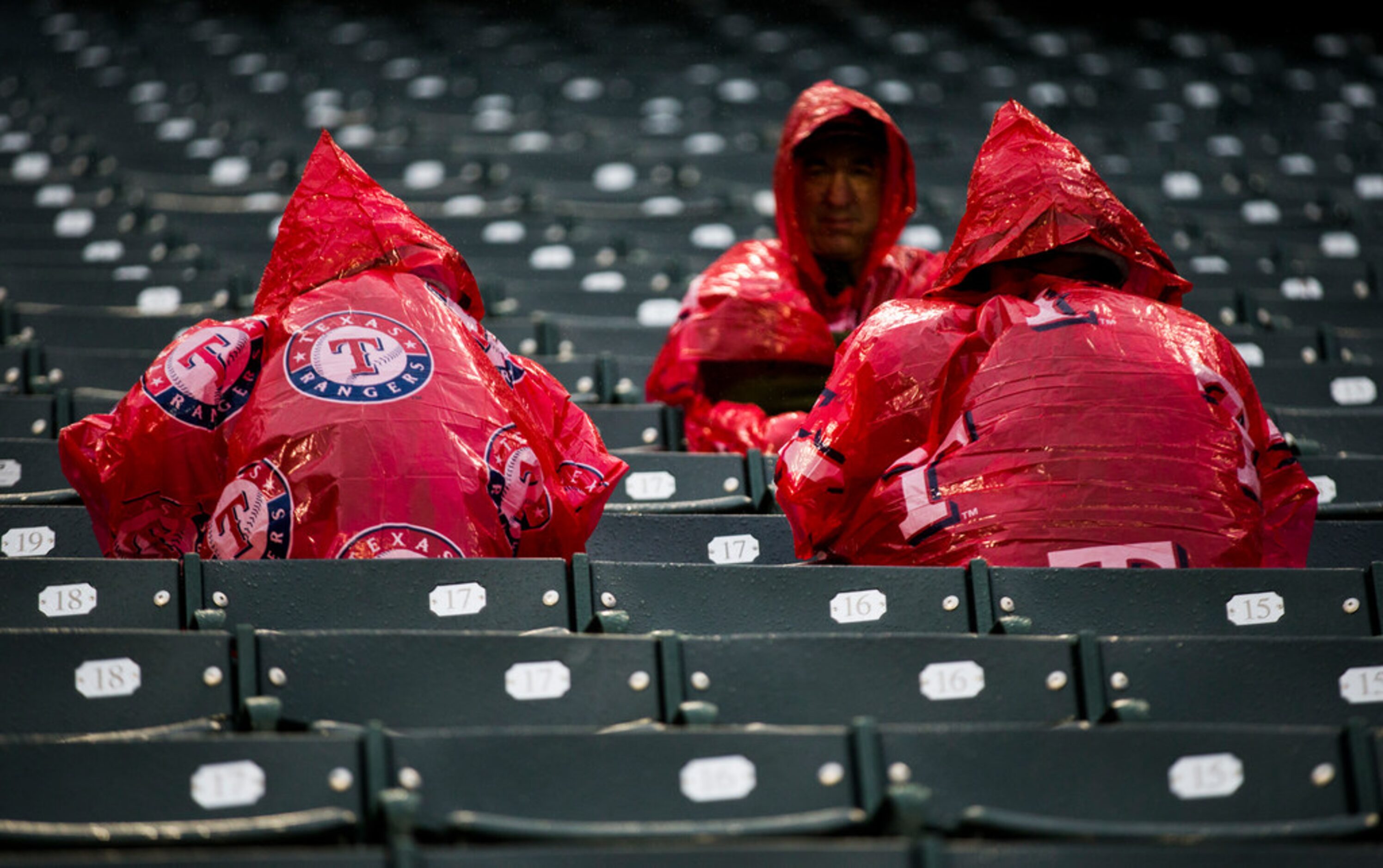 Texas Rangers fans wait in the rain before an MLB game between the Texas Rangers and the...