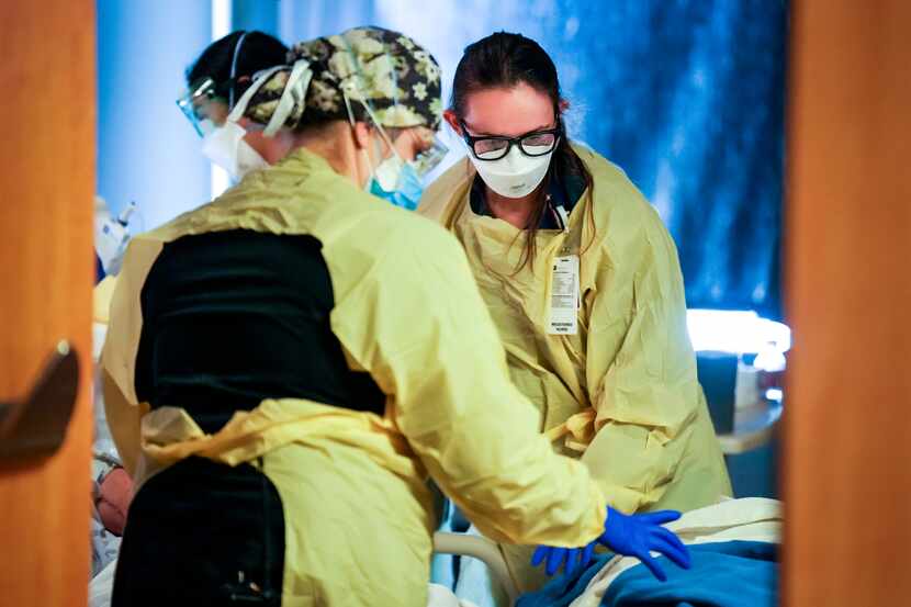 Nurses care for a patient in the COVID-19 unit at Parkland Hospital on Wednesday, Jan. 5,...