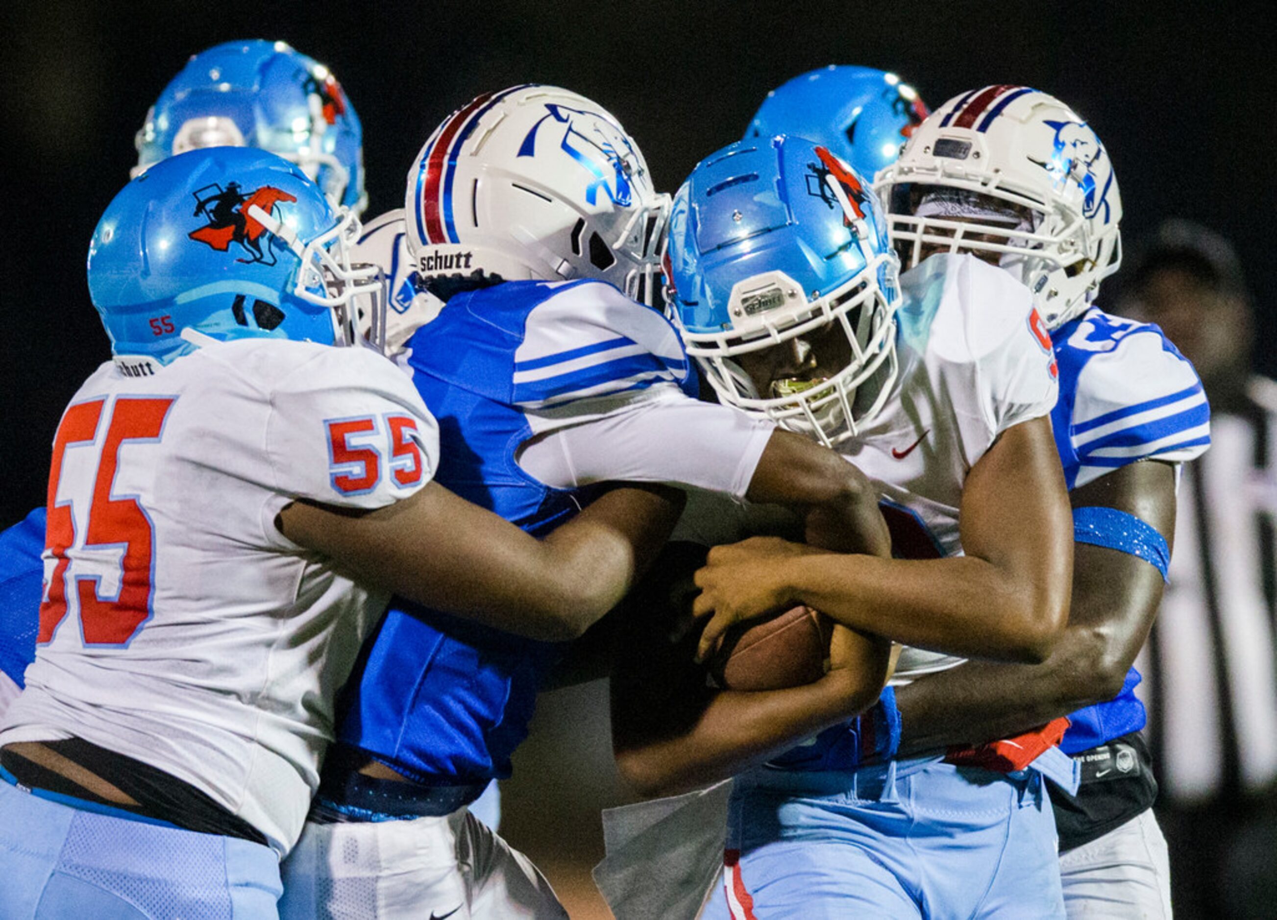 Skyline quarterback Darryl Richardson (9)  is tackled by Duncanville defenders during the...