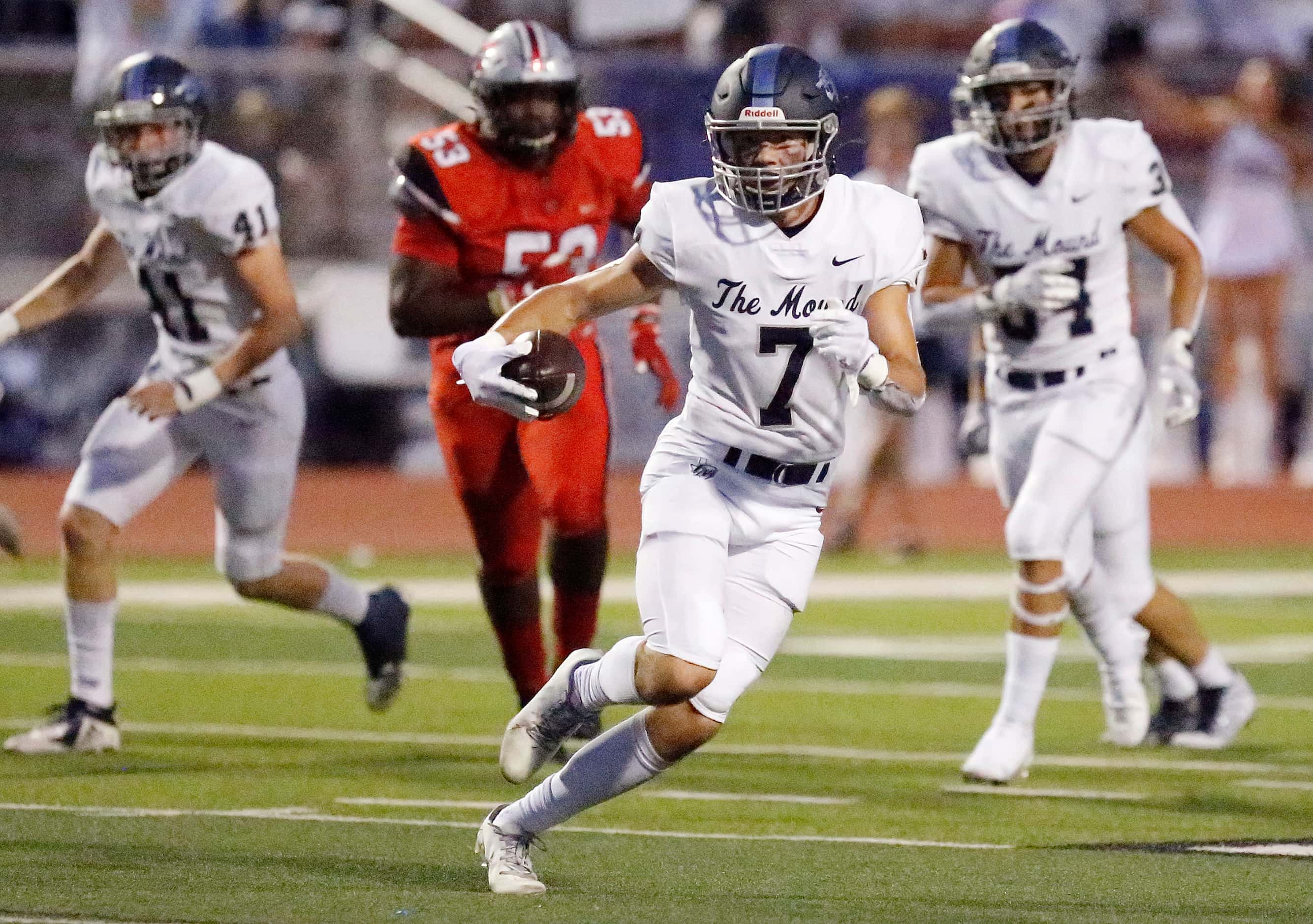 Flower Mound High School safety Cade Harwell (7) runs with an interception during the first...