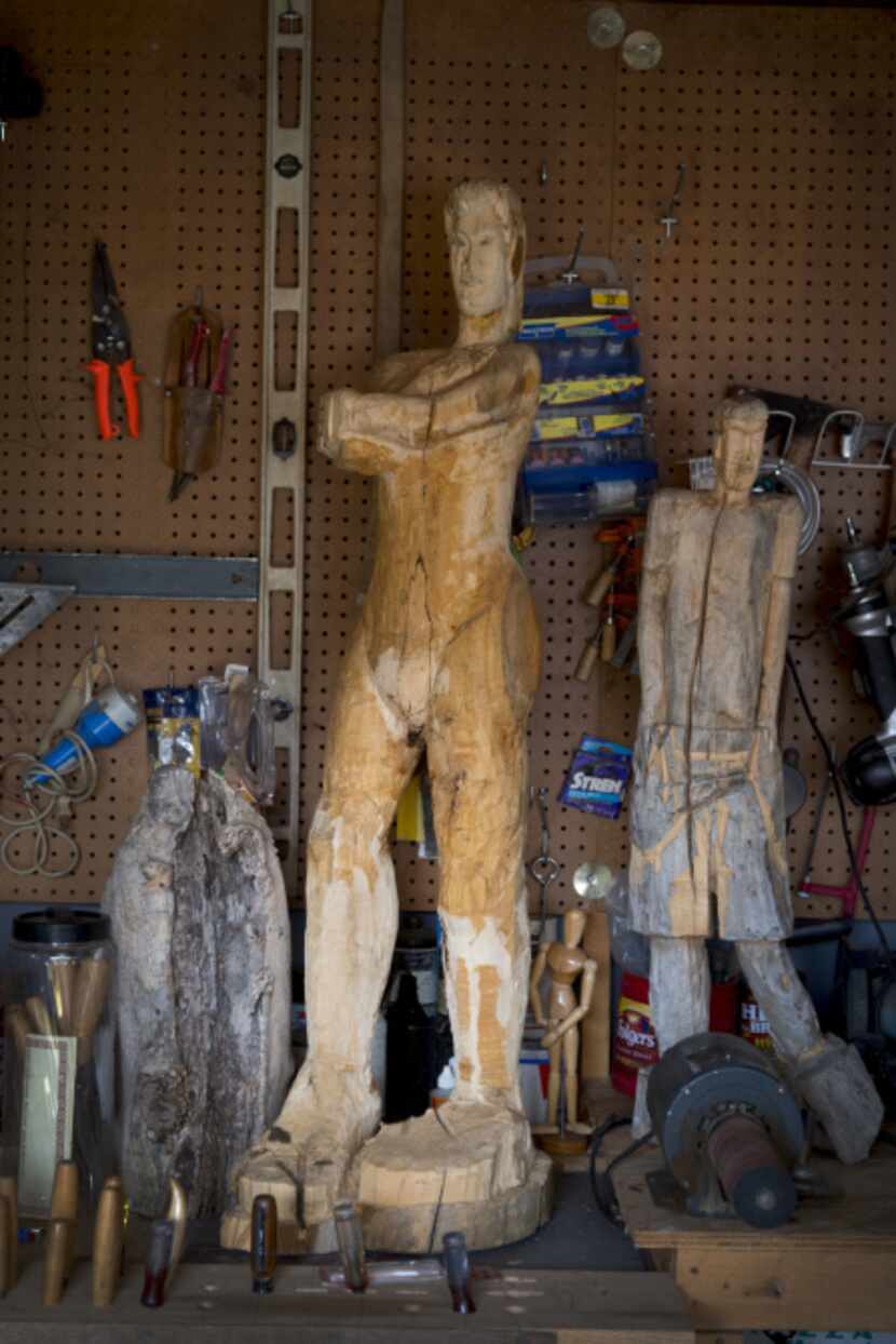 Two works by Duncanville wood carver George Cephus in the shop behind his house on February...