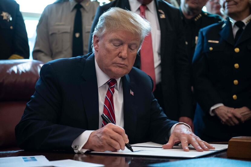 US President Donald Trump signs the first veto of his presidency, overriding a congressional...