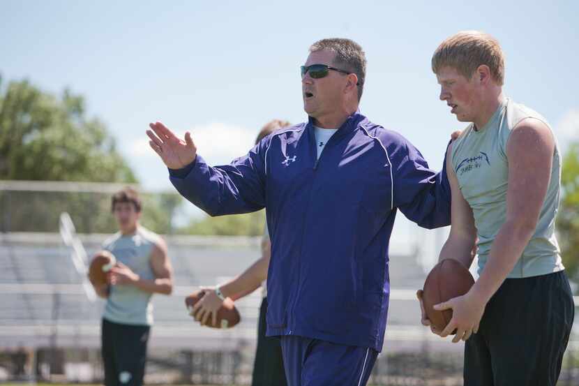Coach Todd Dodge works out with his quarterbacks at Marble Falls High School on March 21,...