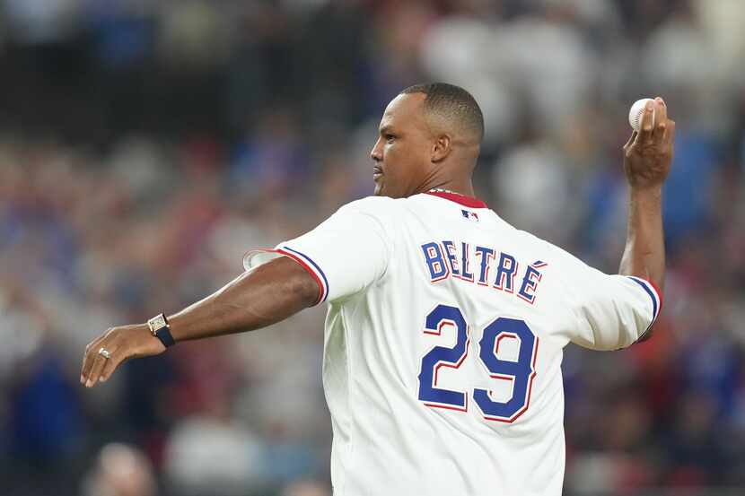 Former Texas Rangers third baseman Adrián Beltré throws the ceremonial pitch to former...