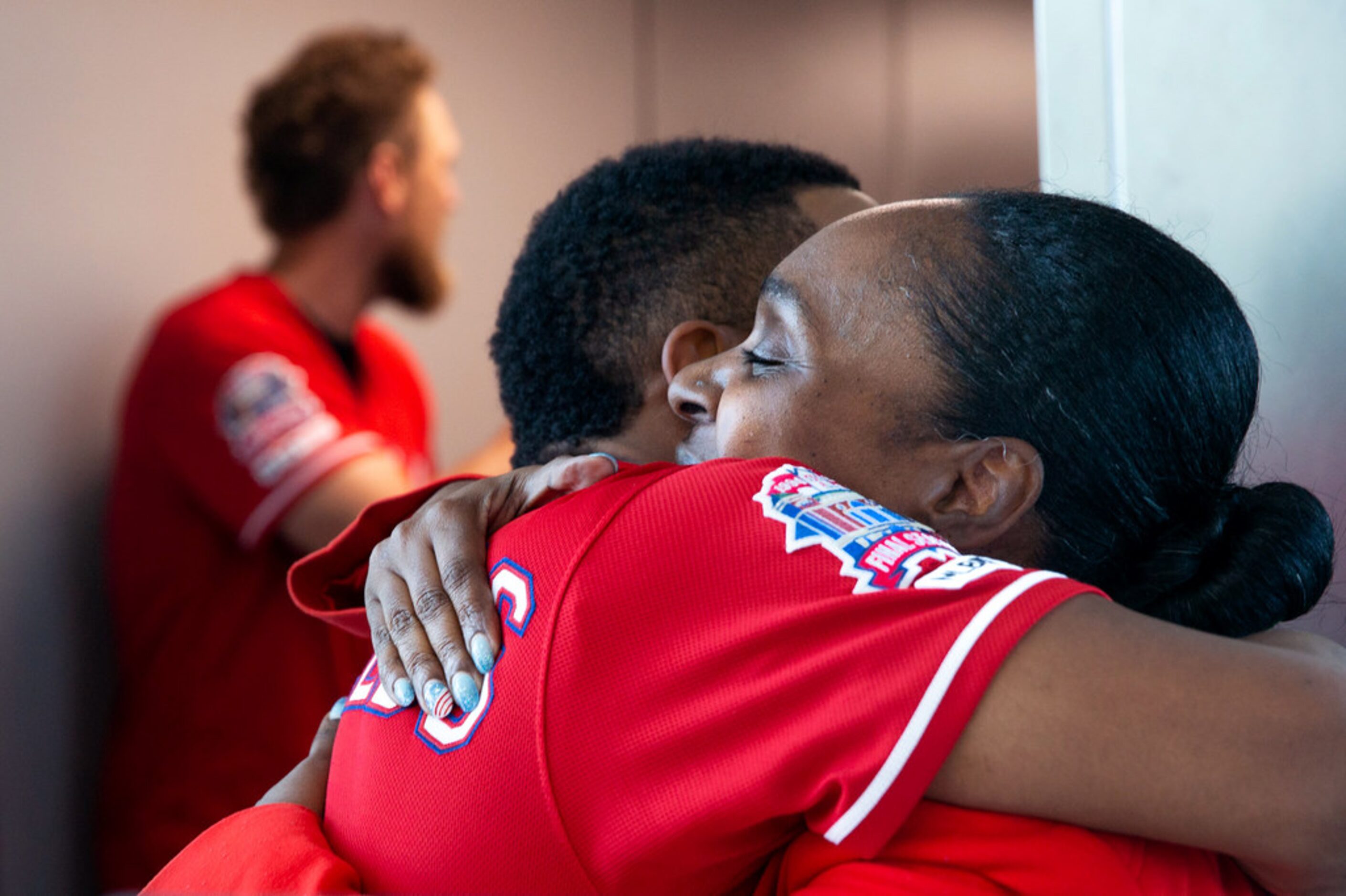 Texas Rangers player Delino DeShields Jr. (center) hugs Southwest Airlines employee Kenya...